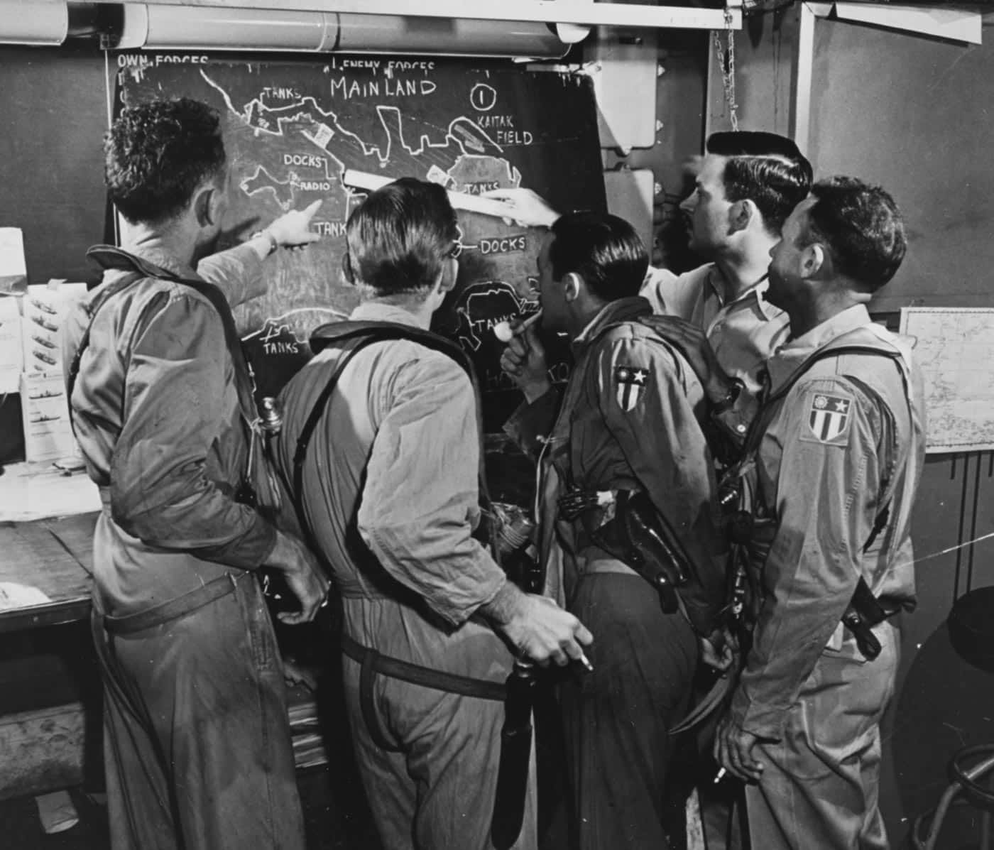 USS Hornet CV-12 pilots study target areas prior to strikes on Hong Kong
