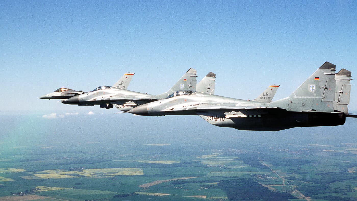 two German Air Force MIG-29 fighters and two Air Force Reserve's F-16 Fighting Falcons flying in a fingertip formation