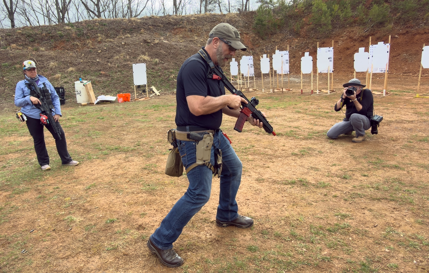 Brian Hill demonstrates kneeling position with AR-15 rifle training