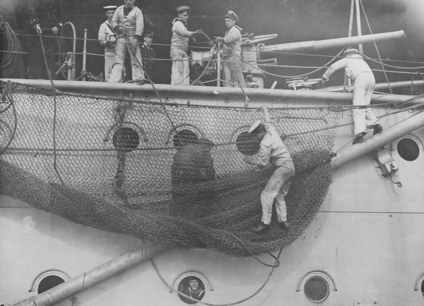 British sailors tend to the torpedo nets on the HMS Dreadnought