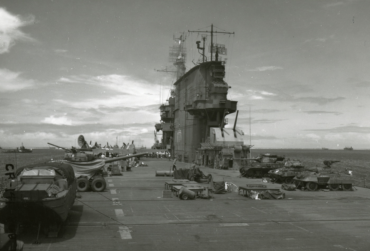 USS Saratoga flight deck showing army equipment arranged for atomic test