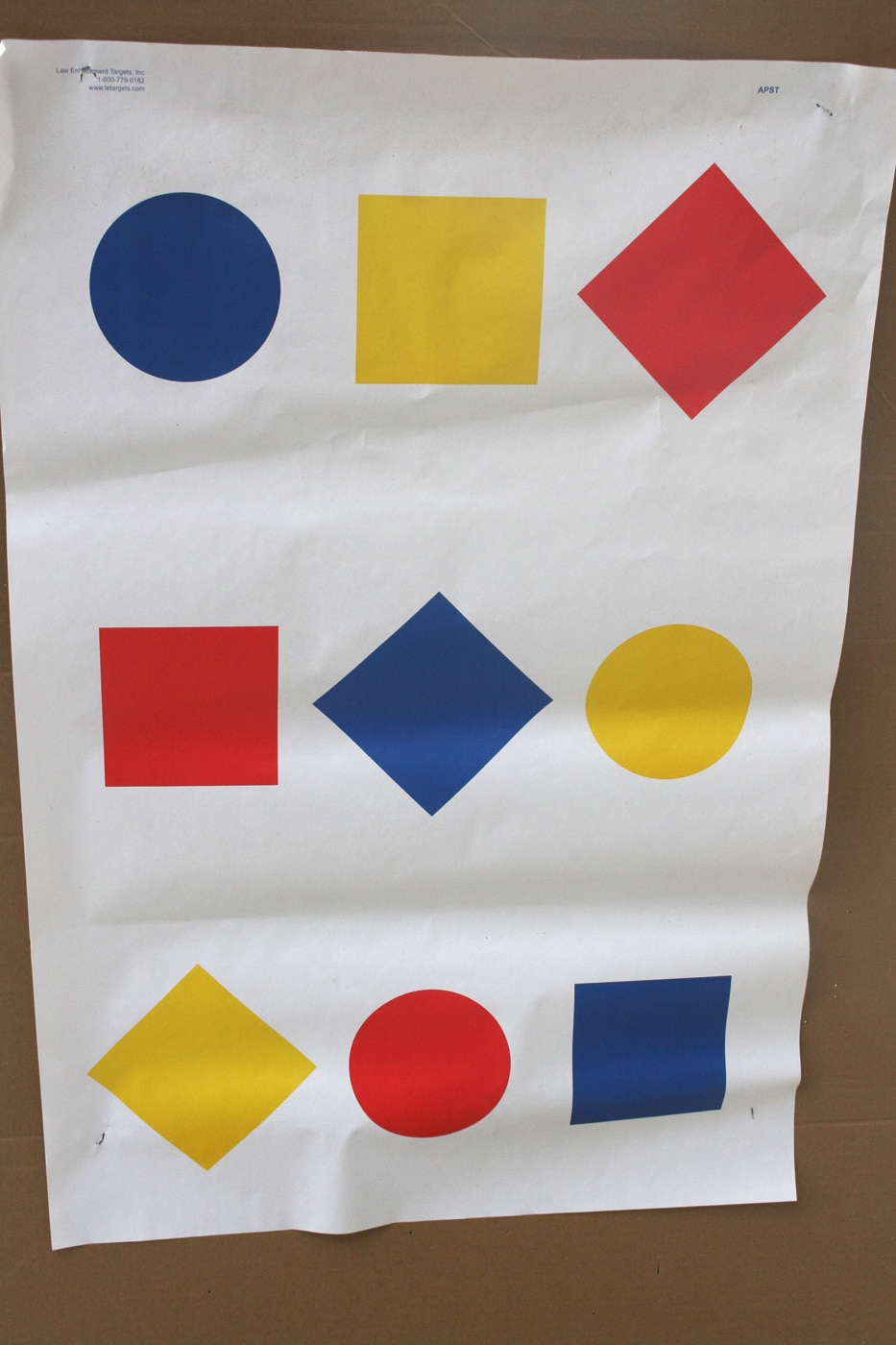 A paper shooting target features a central silhouette surrounded by numbered circles in various colors and basic geometric shapes along the border. Targets like this one open the door to judgmental shooting on almost any public range. A training partner calls out a color, number, or shape, and the armed citizen has to process the cue and engage the correct designator. Combining two pieces of information, such as a color and a shape, raises the cognitive demand significantly. This kind of mental work is what separates static marksmanship practice from genuine defensive preparation. Concealed carriers who train this way build the habit of confirming the right target before pressing the trigger.
