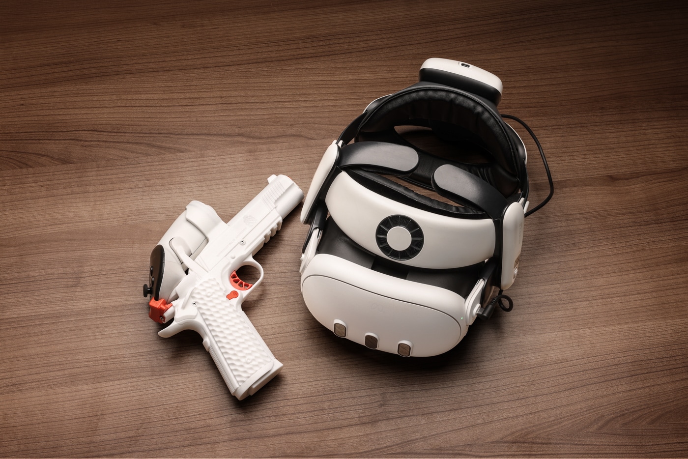 The photo shows a black Meta Quest VR headset resting beside a Springfield 1911 TRP handset that serves as the firearm controller. These two components form the core hardware of the Ace VR Shooting Simulator, a virtual shooting range built for home use. The headset runs the simulation software, while the weighted handset replicates the size, balance and trigger pull of the live-fire pistol. That tactile match is what drives real-world skill transfer in this VR firearms trainer. Configured like the 5-inch rail-equipped TRP, the controller gives 1911 fans a familiar grip angle and feel. For roughly the monthly cost of a small box of 9mm, a shooter can practice with this setup as often as they like.