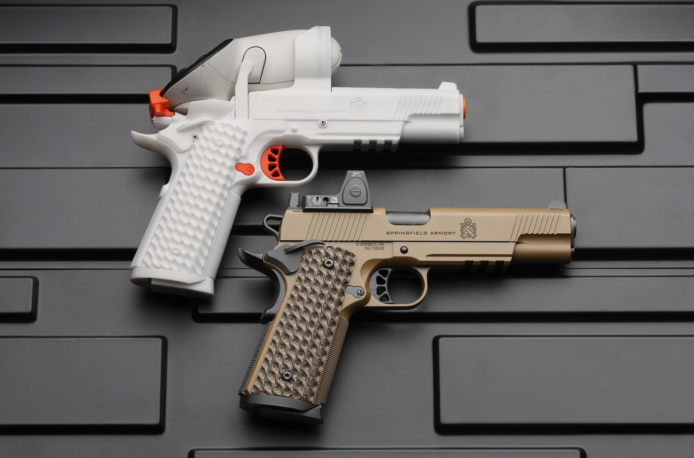 The photo shows the Ace 1911 TRP handset displayed side by side with the live-fire Springfield Armory 1911 TRP pistol for comparison. Placing the two together highlights how closely the controller for the Ace VR Shooting Simulator matches the production gun. The replica reproduces the size, weight, texture and grip angle of the real pistol. That close congruence is what drives real-world skill transfer from the virtual trainer to live fire. AceXR and Springfield Armory worked together to keep a high degree of agreement between the handset and the production TRP. Matching the feel of the actual gun is what separates a true shooting simulation from a video game.