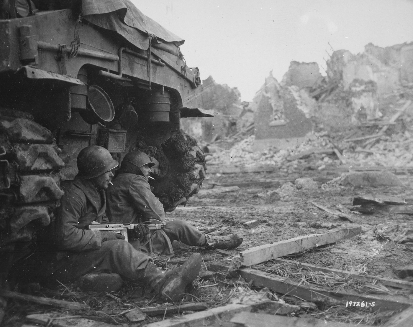 American soldiers seek shelter behind a tank