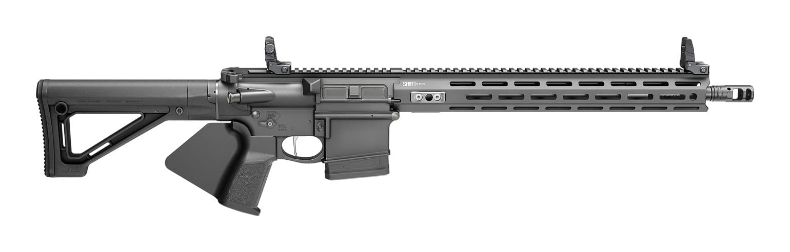 Shown in detail are the fixed stock and deployed flip-up sights of a California-compliant SAINT Victor chambered in 5.56 NATO. This AR-15 is the flagship of the CA-compliant SAINT Victor family, designed as the straightforward option for California shooters. A fixed rear stock replaces the telescoping unit a standard AR would wear, satisfying the state's featureless requirement. The rear iron sight carries two apertures, giving the shooter a choice between fine accuracy and faster sight picture. Tool-free adjustment lets the backup sights stay zeroed alongside any optic mounted to the Picatinny rail. Combined with the "fin" grip and a 10-round magazine, the semi-auto rifle meets California law without giving up performance.