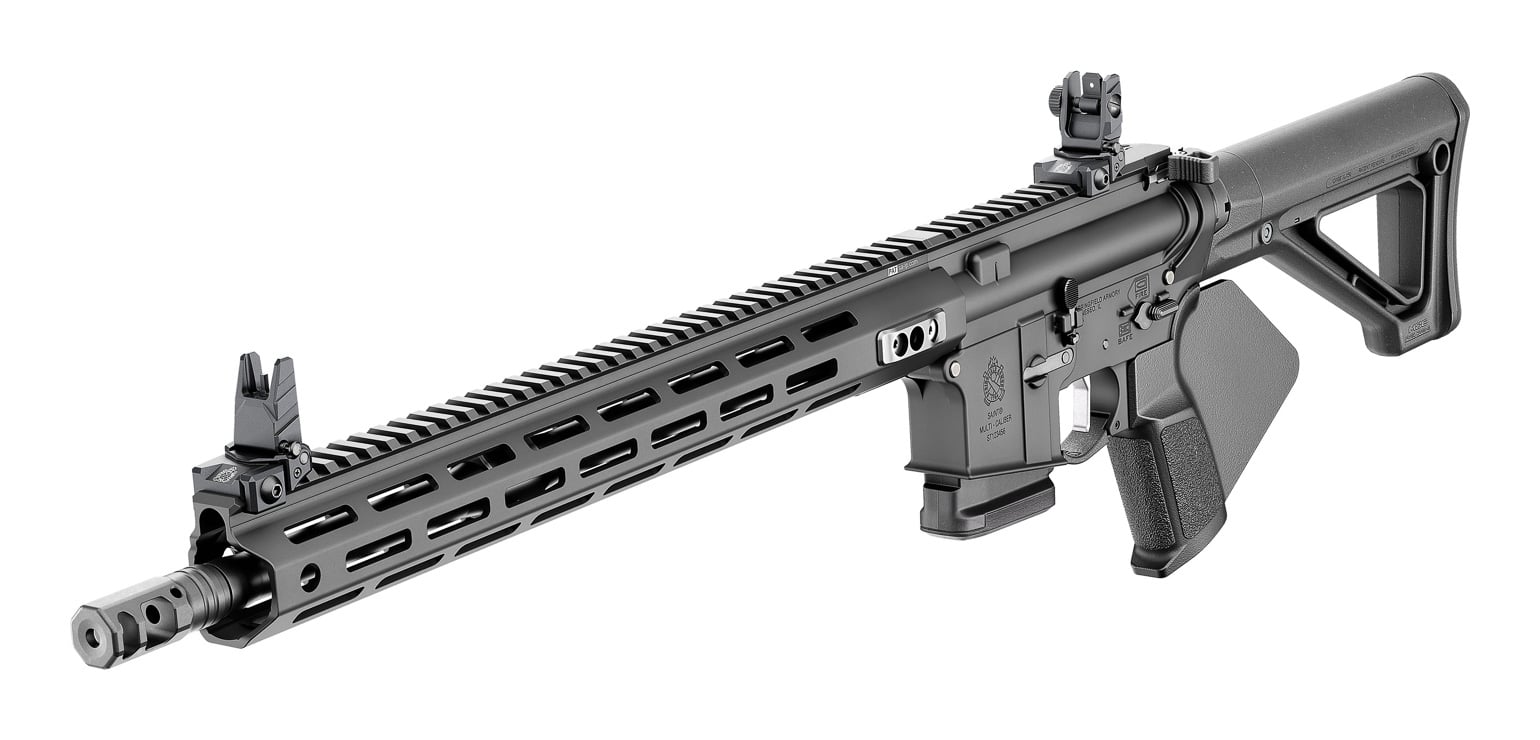 The photograph focuses on a California-compliant Springfield SAINT Victor 5.56 AR-15, highlighting its fixed rear stock and raised flip-up iron sights. As the 5.56/.223 model, this is the most popular rifle in the CA-compliant SAINT Victor line. The fixed, non-telescoping stock is one of the changes that keeps the semi-auto rifle within California's featureless rules. Its folding sights are high-quality units, with two rear apertures that let users prioritize accuracy or quick target acquisition. Both sights adjust without tools, so the rifle can be zeroed even when a shooter packs only the gun and ammunition. Paired with the featureless "fin" grip, these features make the 5.56 SAINT Victor a compliant yet capable choice for California gun owners.