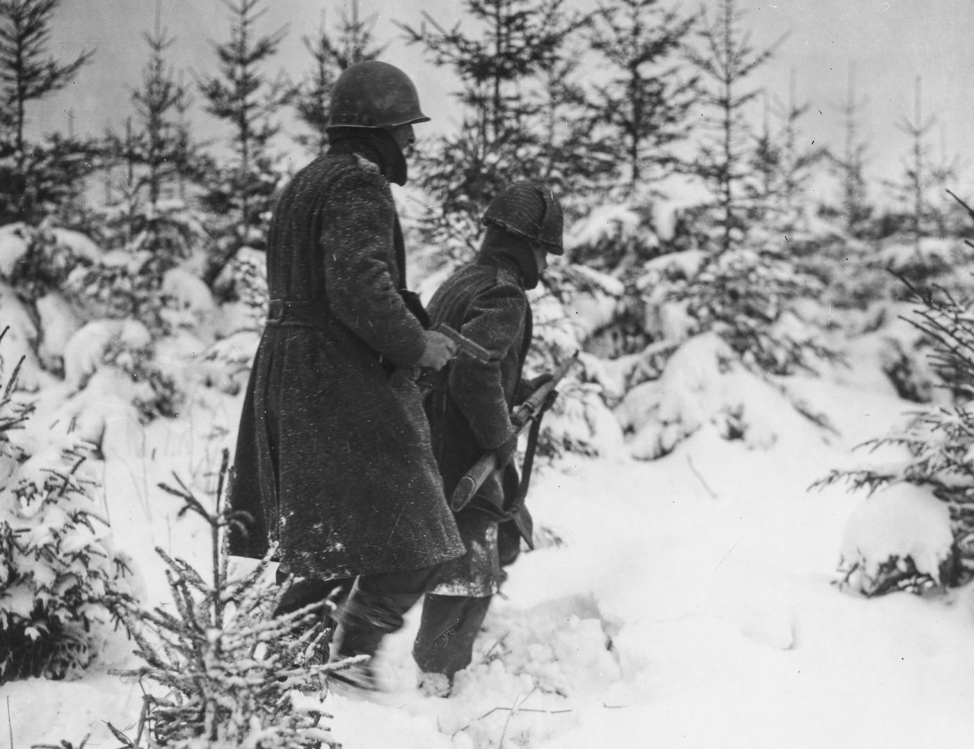 US soldiers of the 82nd Airborne armed with M1911 pistols search for German soldiers in World War II