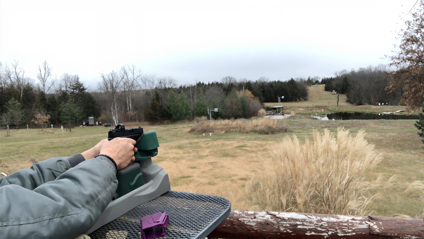 author shooting the Hellcat 380 from a bench rest
