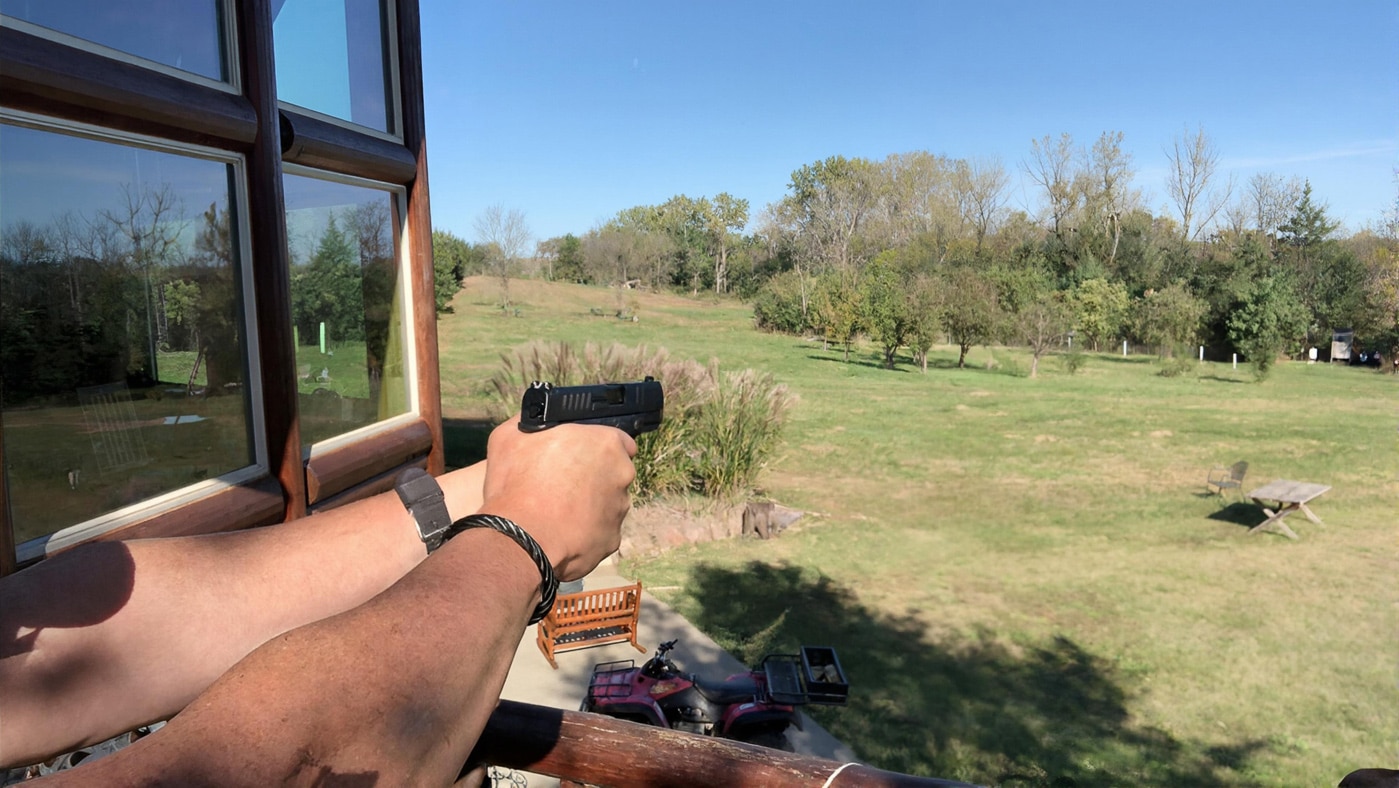 author shooting the Hellcat 380 on his 200 yard range