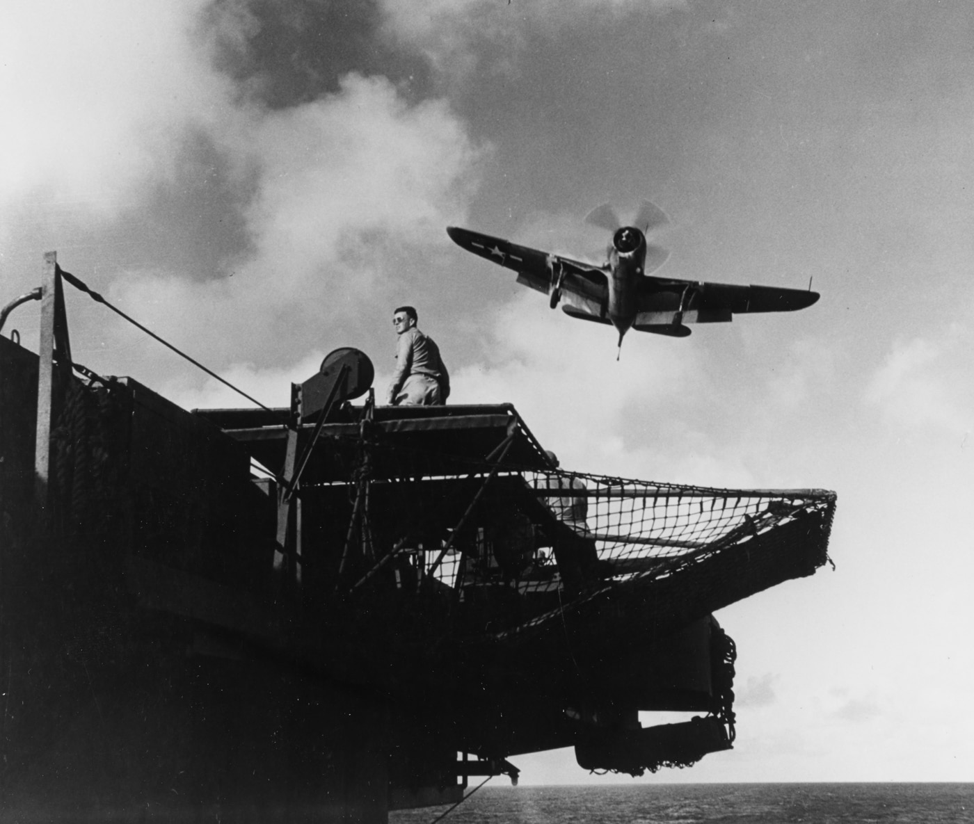 landing officer aboard USS Franklin CV-13 waves off a Curtiss SB2C Helldiver