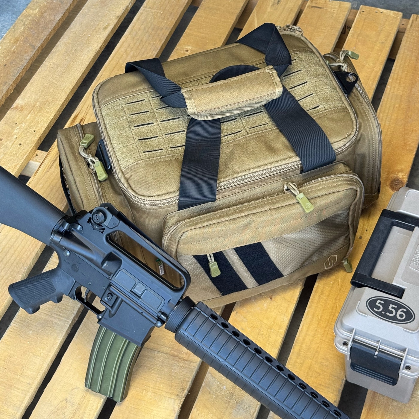 This tactical range bag uses a semi-rigid frame that holds its shape even when empty, unlike floppy gear bags. Inside, an adjustable center divider and three cushioned pistol sleeves keep handguns separated and protected from scratches. A removable magazine panel secures both single and double stack magazines and attaches with hook and loop.
