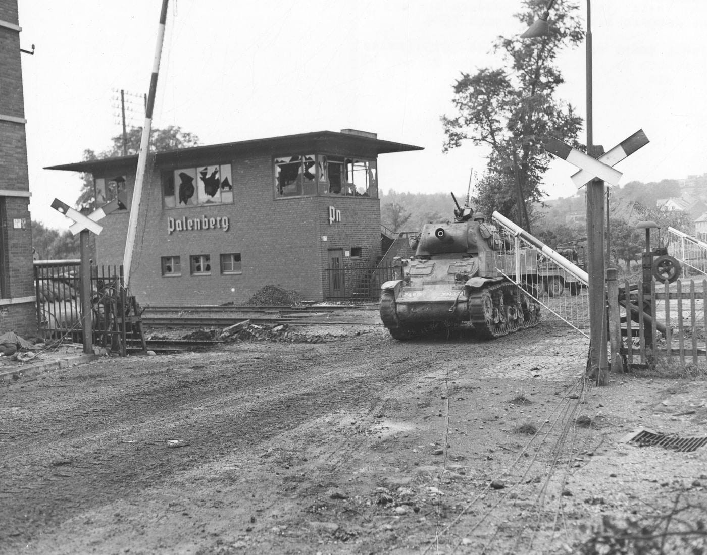 M8 howitzer moves through Palenberg Germany railway station October 1944