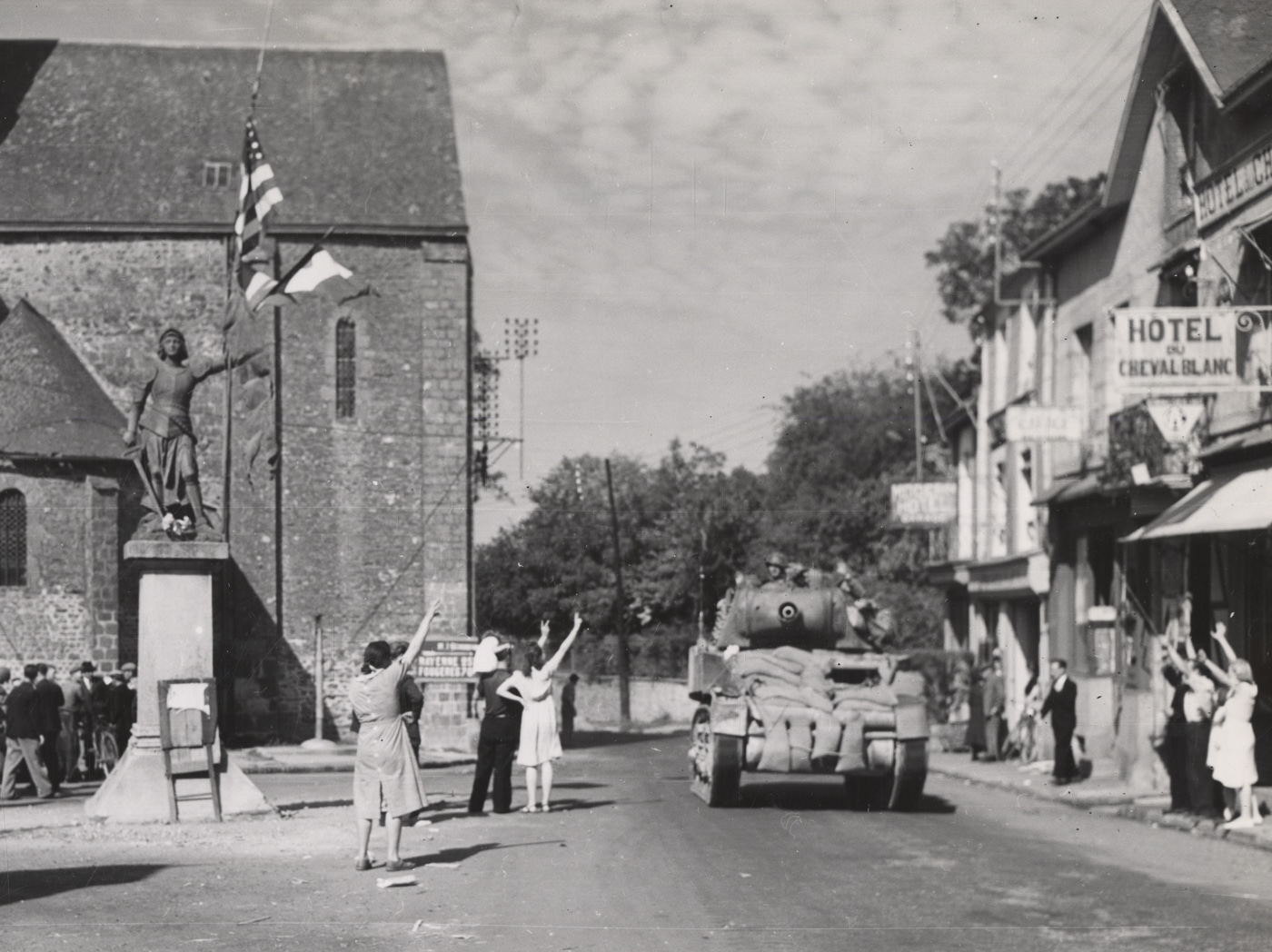 M8 with sandbag armor of 3rd Armored Division enters liberated Javron France
