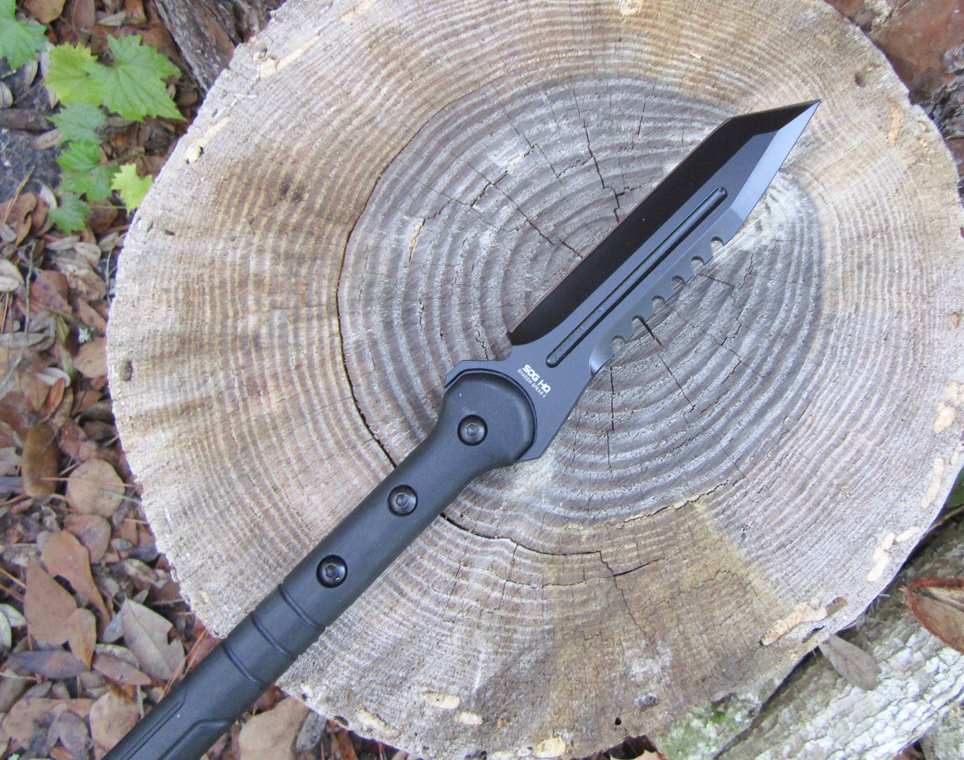 SOG Shadow Spear II outdoor evaluation testing the tactical hunting spear's balance, throwing performance, and tanto-style 420 stainless steel blade. Field testing the SOG Shadow Spear II survival spear outdoors, demonstrating the durable glass-filled nylon haft and black powder-coated tanto point.