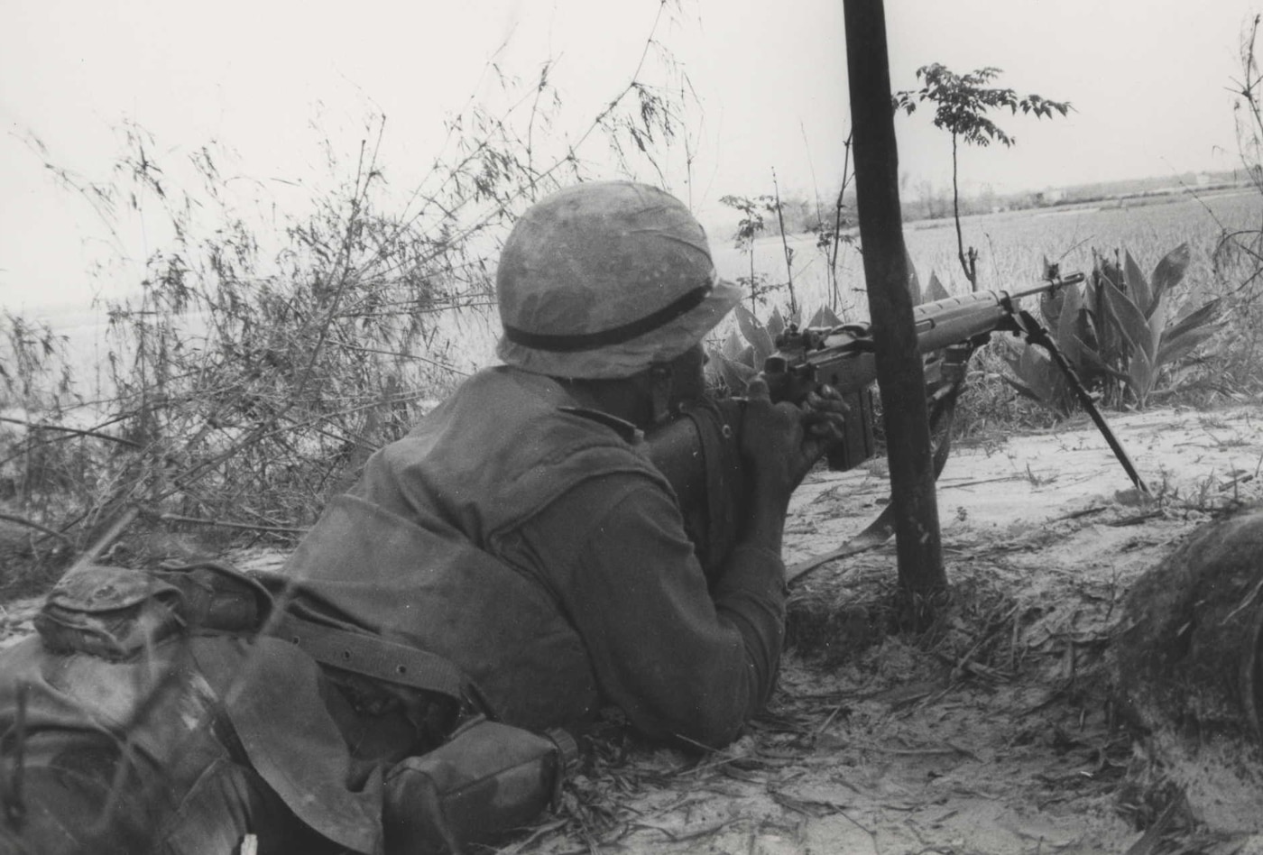 US Marine in prone position firing M14 rifle in Vietnam War