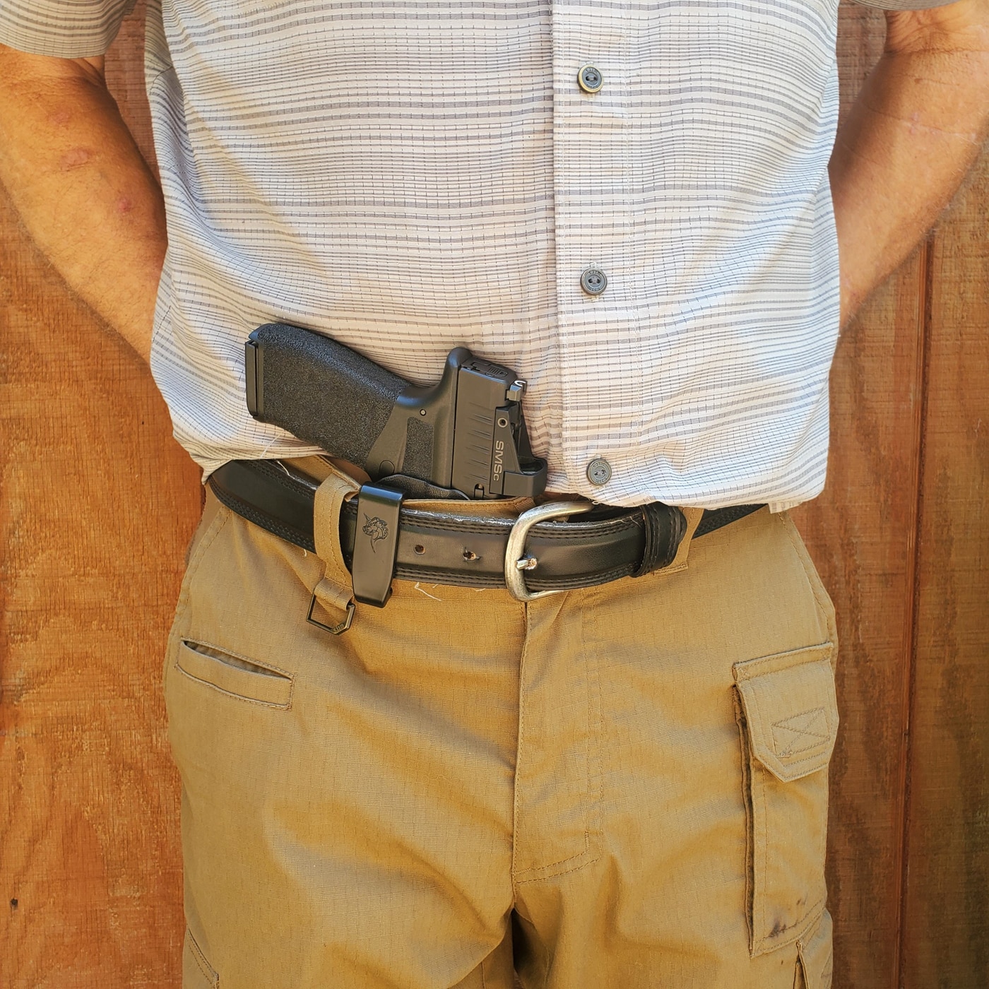 author demonstrating the Hellcat Pro carried in tuckable holster