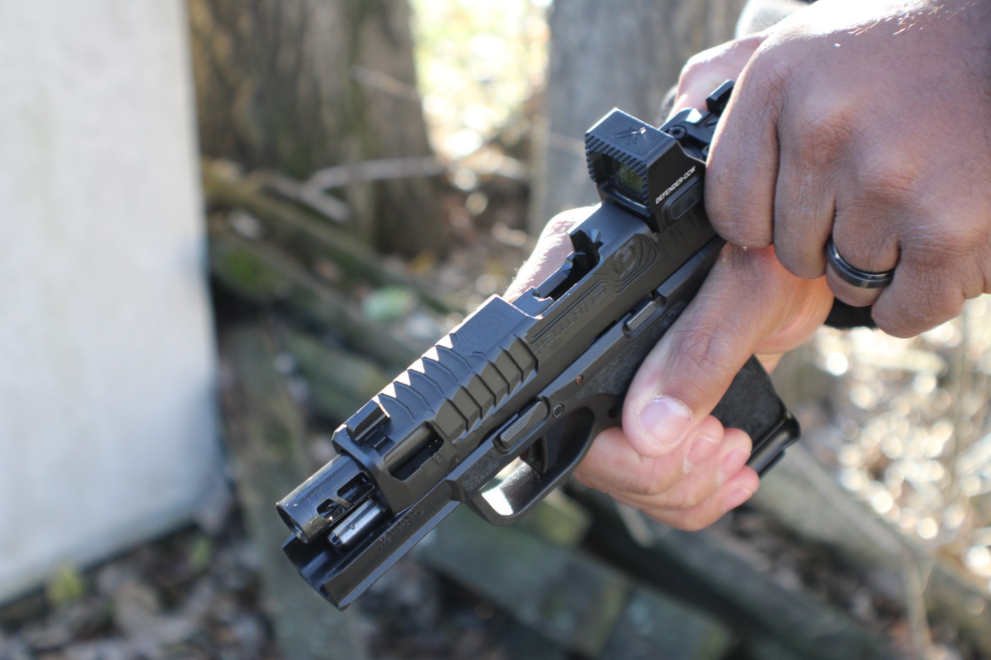 author pulling the slide back on the Floyd Custom Shop Hellcat Pro ccw pistol