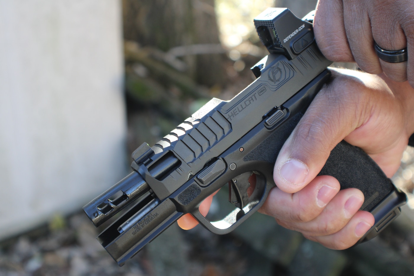 author retracting the slide on the Floyd Custom Shop Hellcat Pro pistol
