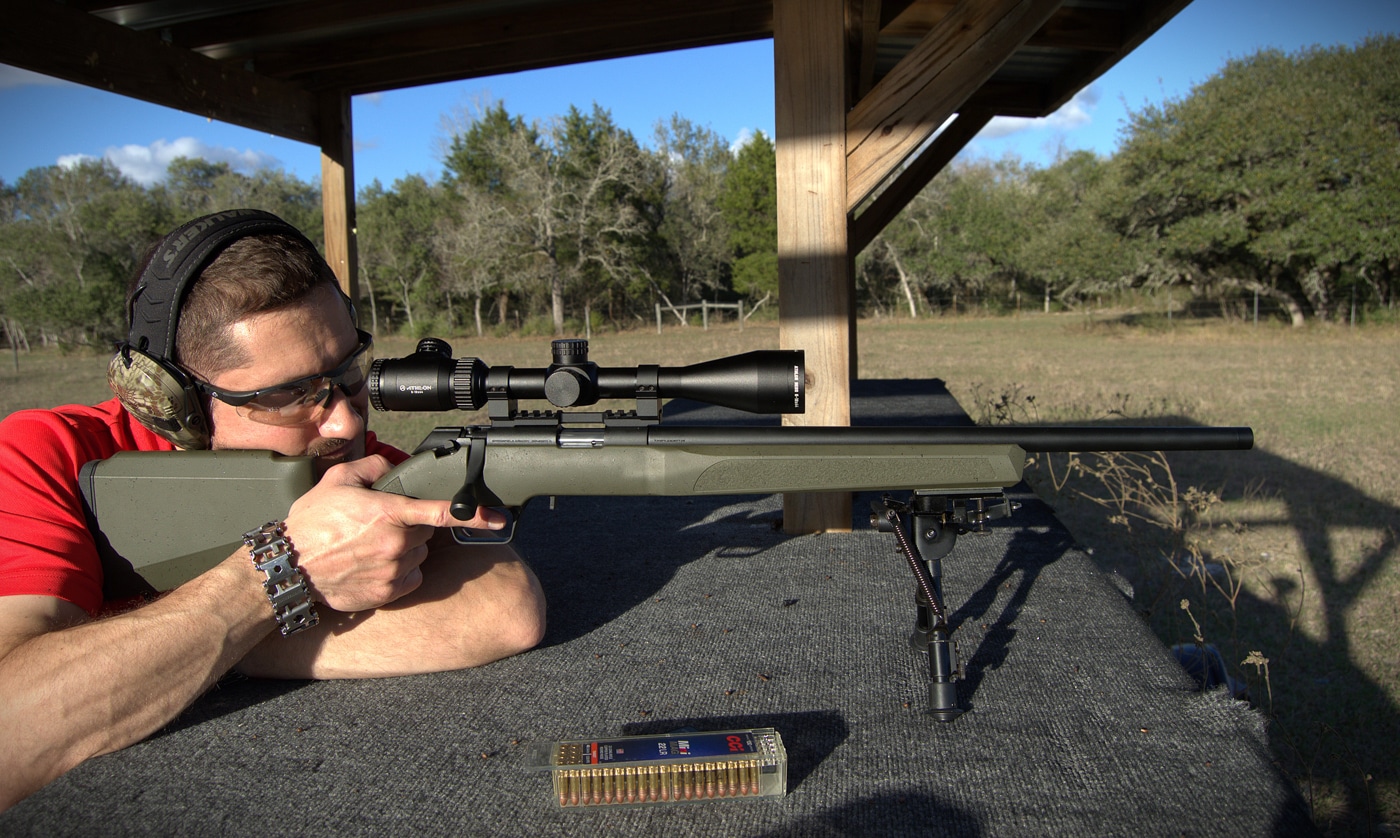 author shooting rifle from the bench