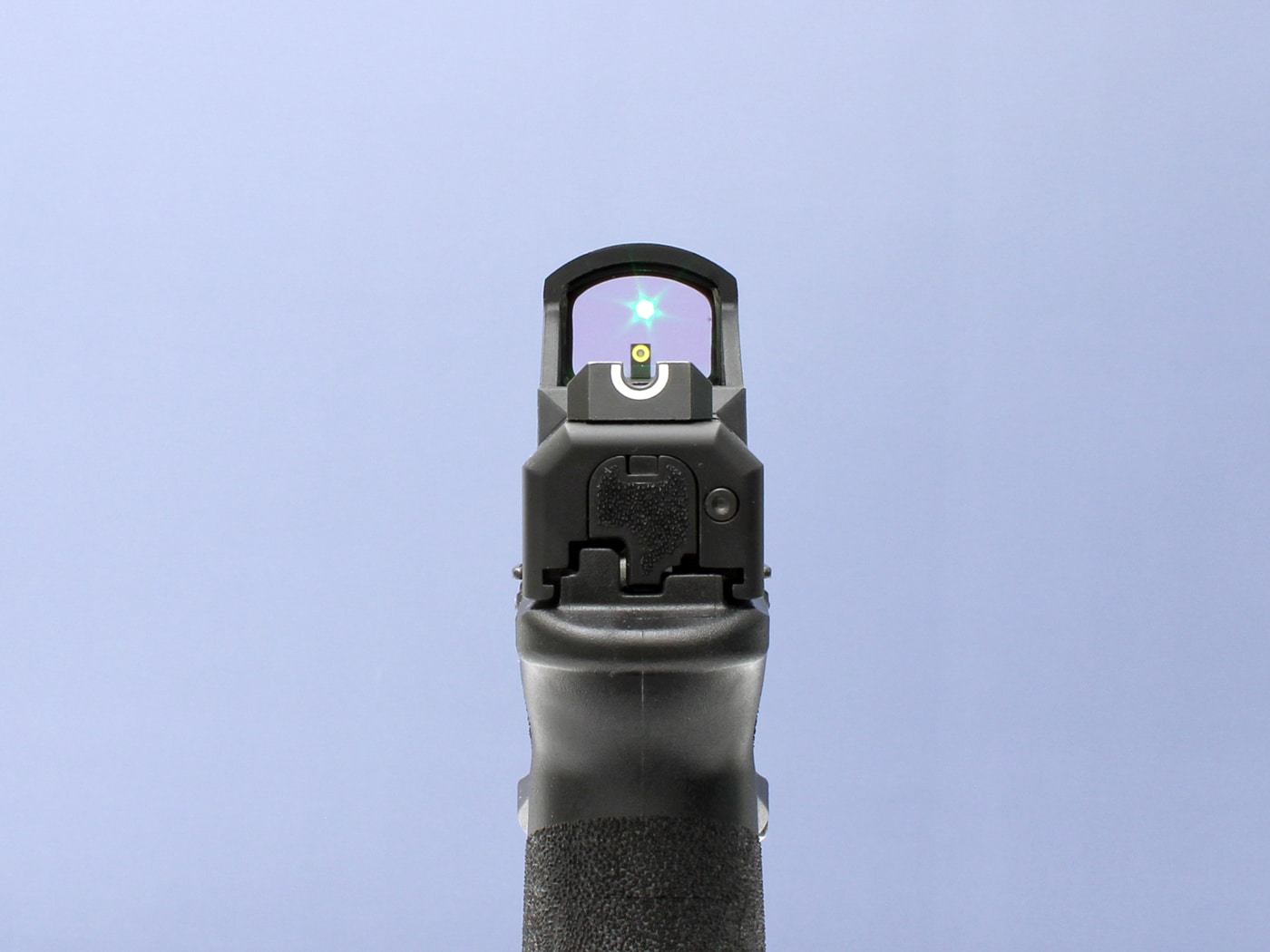 showing iron sights co-witnessing with a green dot sight