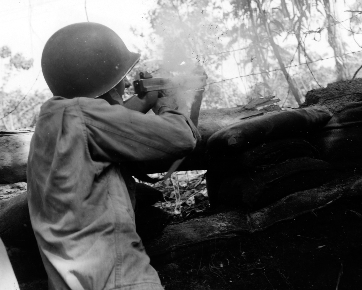 American soldier fires his Thompson submachine gun at Japanese troops on Bougainville 1944