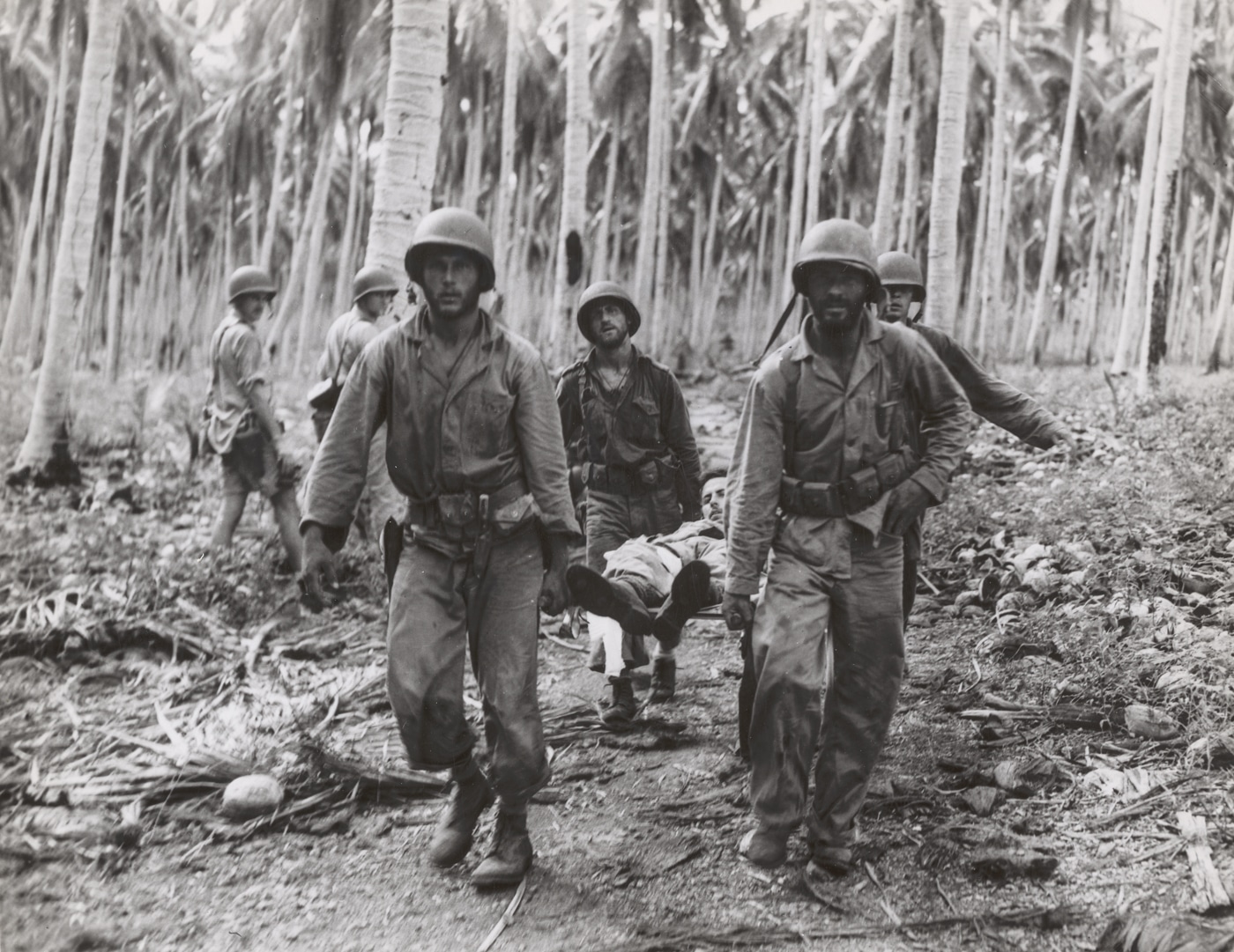 Marines carry out a wounded buddy who had been shot by a Japanese sniper