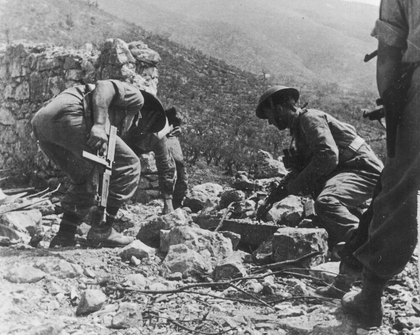 Polish soldiers armed with M1 Thompson submachine guns above German bunker