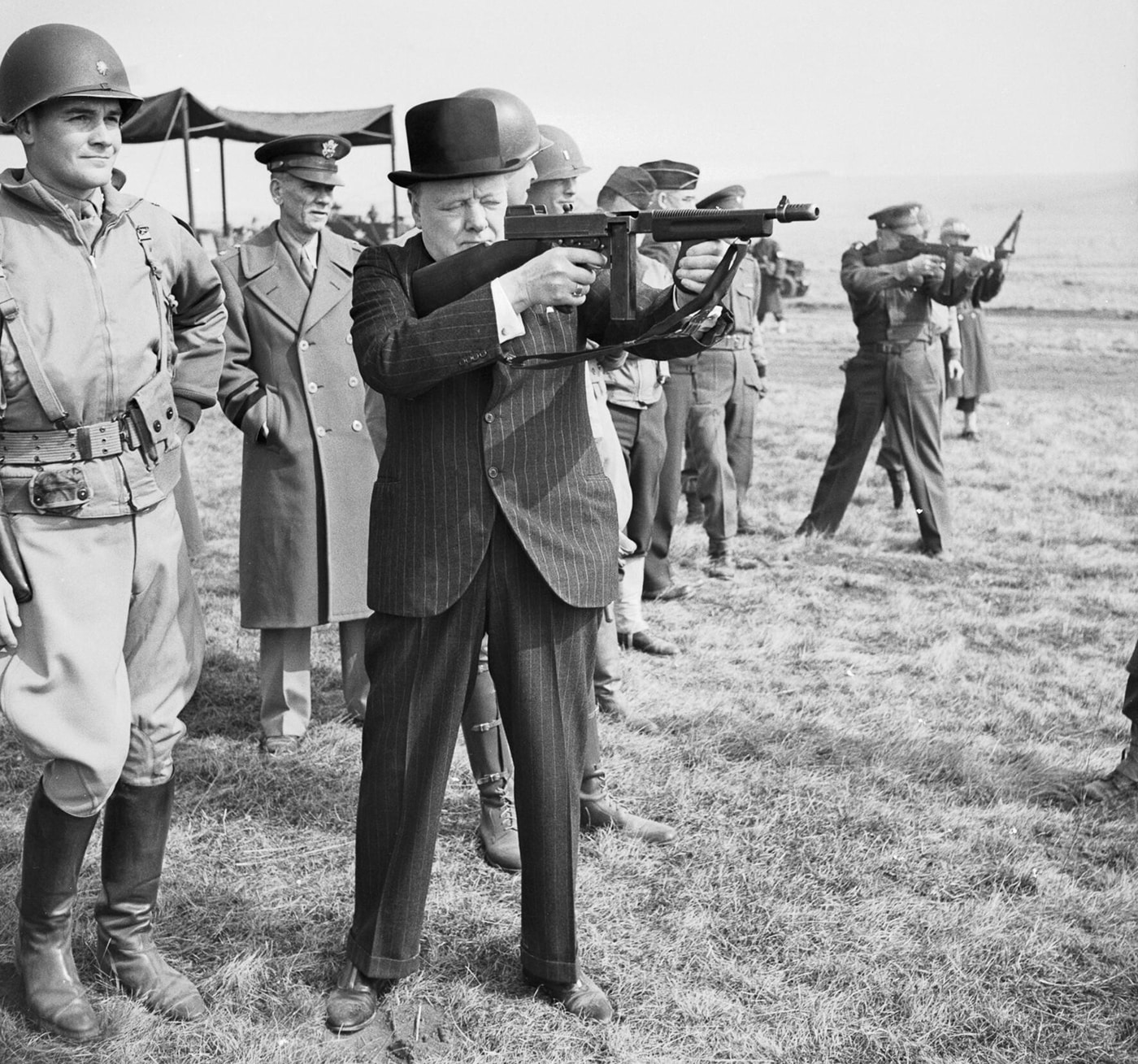 Prime Minister Winston Churchill fires a Thompson submachine gun with Supreme Allied Commander General Dwight D Eisenhower in England 1944
