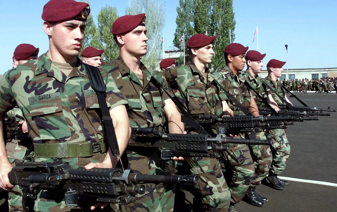 US Army 82nd Airborne soldiers carrying M240 machine guns while on parade