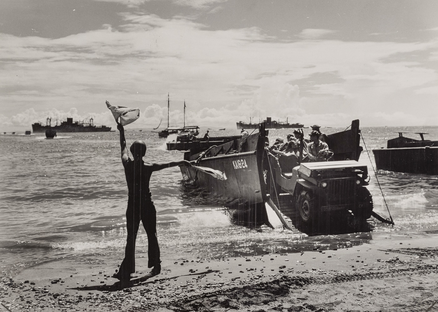 US Coast Guard crew brings landing craft onto Guadalcanal beach with Jeeps and men