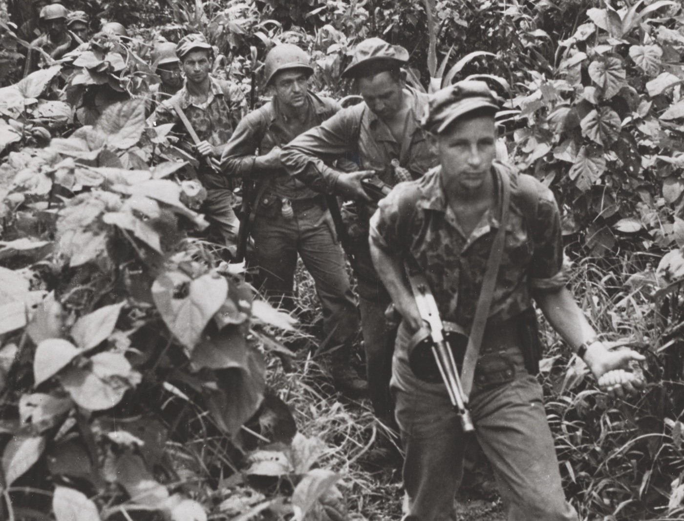US Marine with Thompson submachine gun leads a patrol on New Britain in December 1943