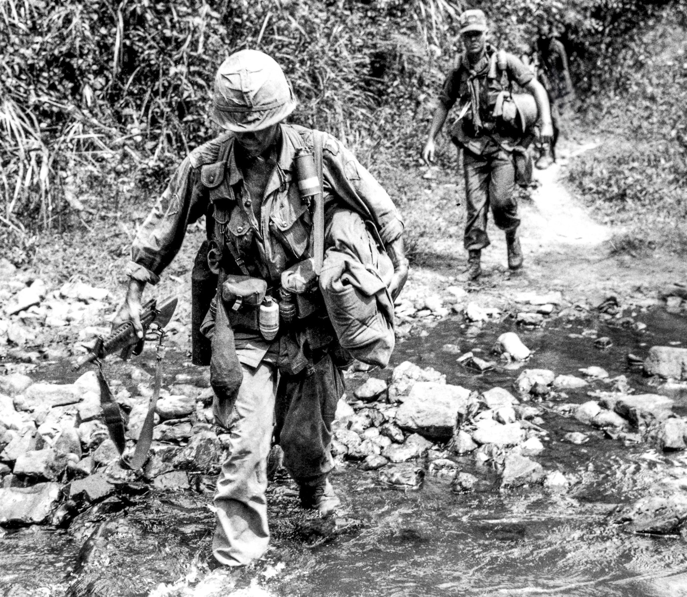 US soldiers in 101st Airborne Division cross a creek near Tuy Hoa Republic of Vietnam during the war