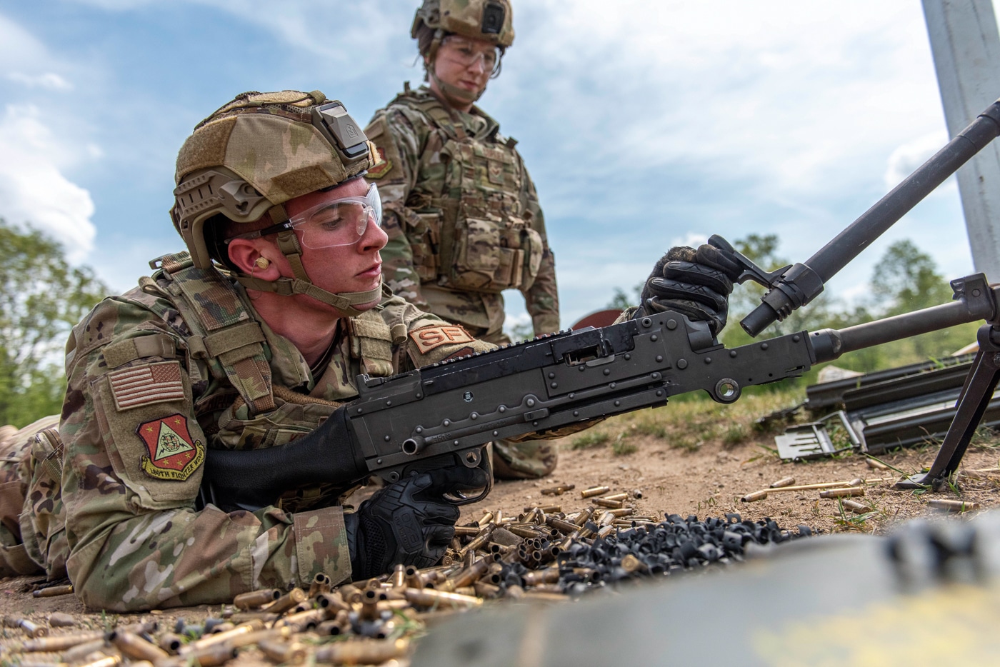 USAF Airman changes barrel on M240 during machine gun training