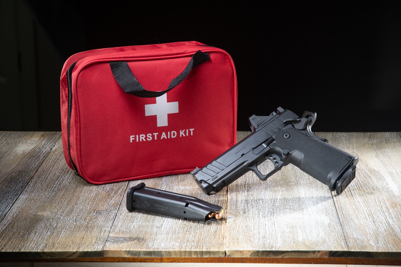 lead image for training scars article showing a Springfield Armory 1911 DS Prodigy and first aid kit