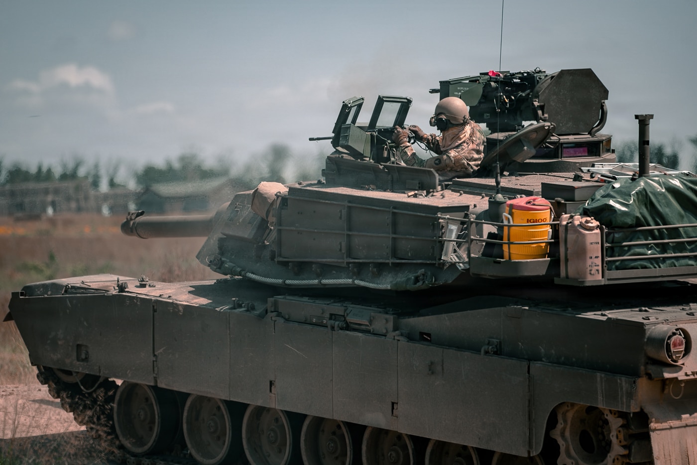 soldier firing M240 machine gun on M1A2 Abrams tank