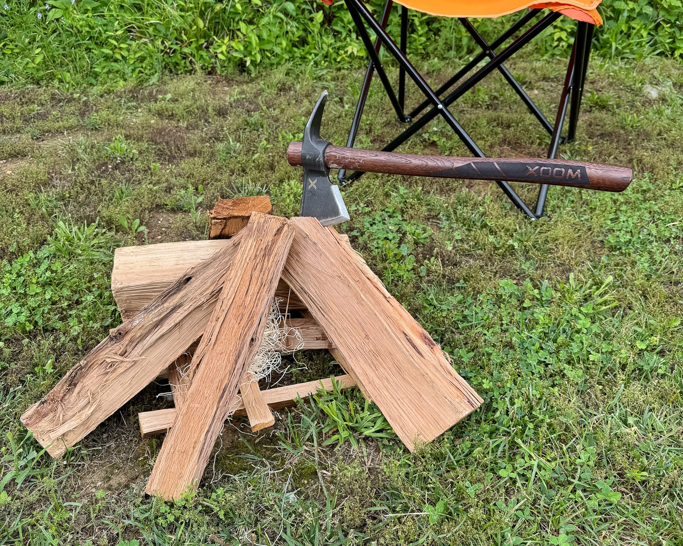using a survival axe to cut firewood and make kindling for a fire