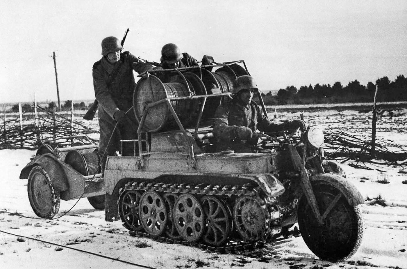 German soldiers on a Kettenkrad with trailer laying communication cables