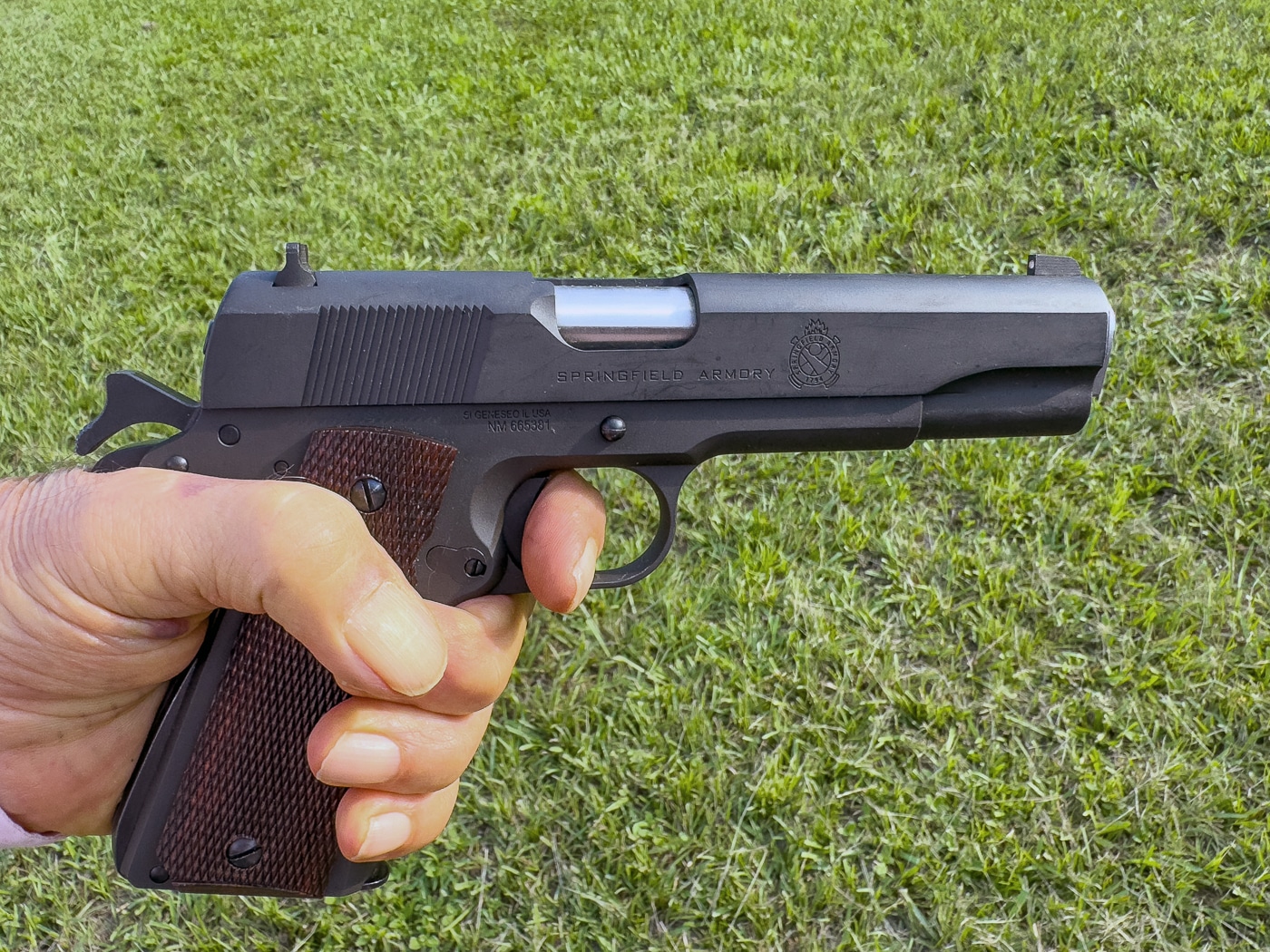 Massad Ayoob demonstrates trigger reach of Springfield 1911 Mil Spec