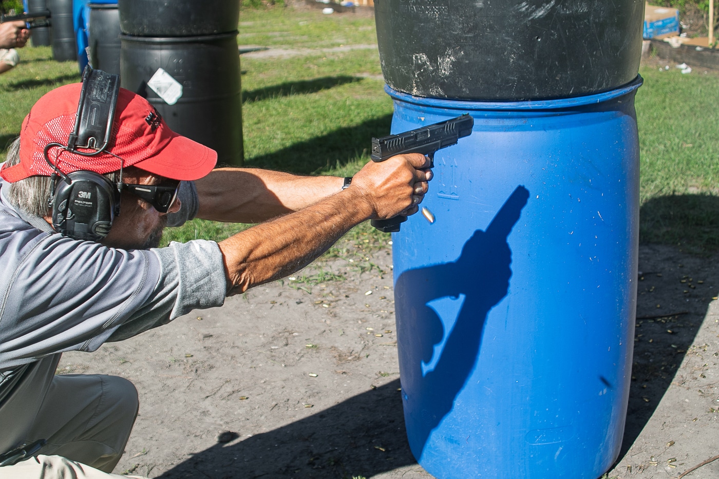 Massad Ayoob shooting a Springfield Armory XD-M pistol from behind cover