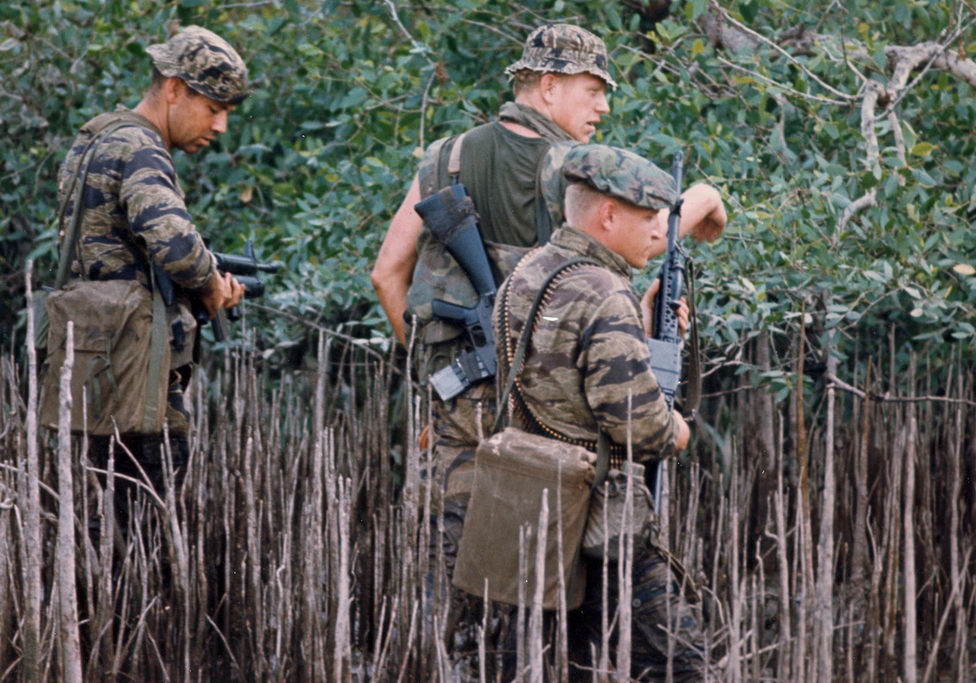 US Navy SEALs move through the Mekong Delta armed with Stoner 63 machine gun