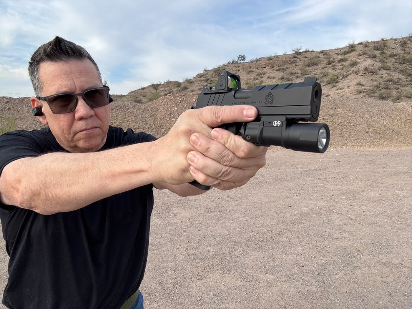 author shooting the 1911 Emissary AOS 9mm