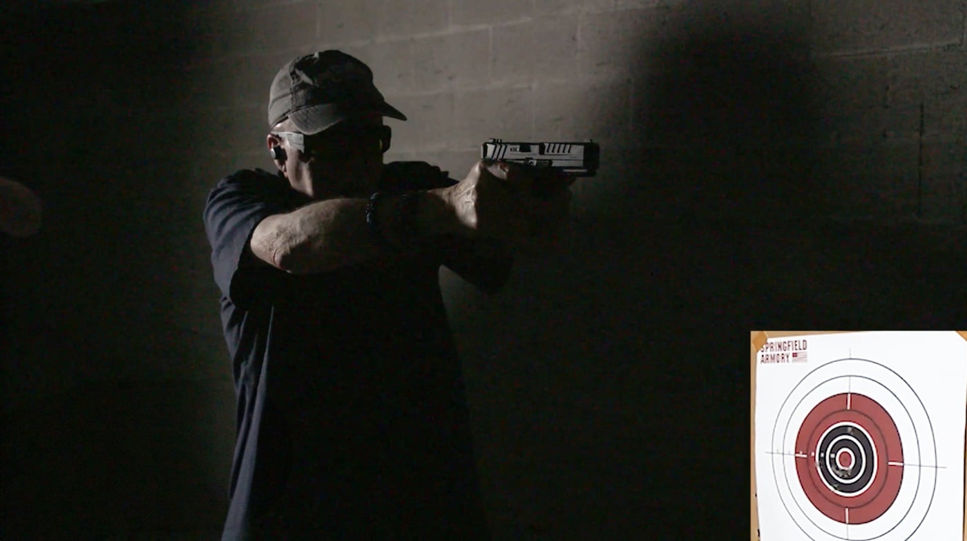 author testing the sights on a darkened indoor range