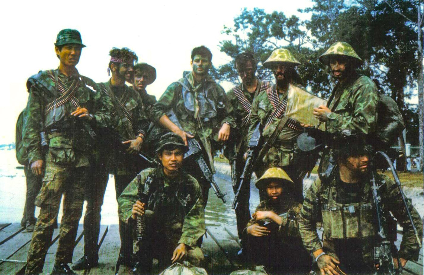 group photo of US Navy SEALs in Vietnam one armed with Stoner 63A1 Mk 23 Mod 0 Commando