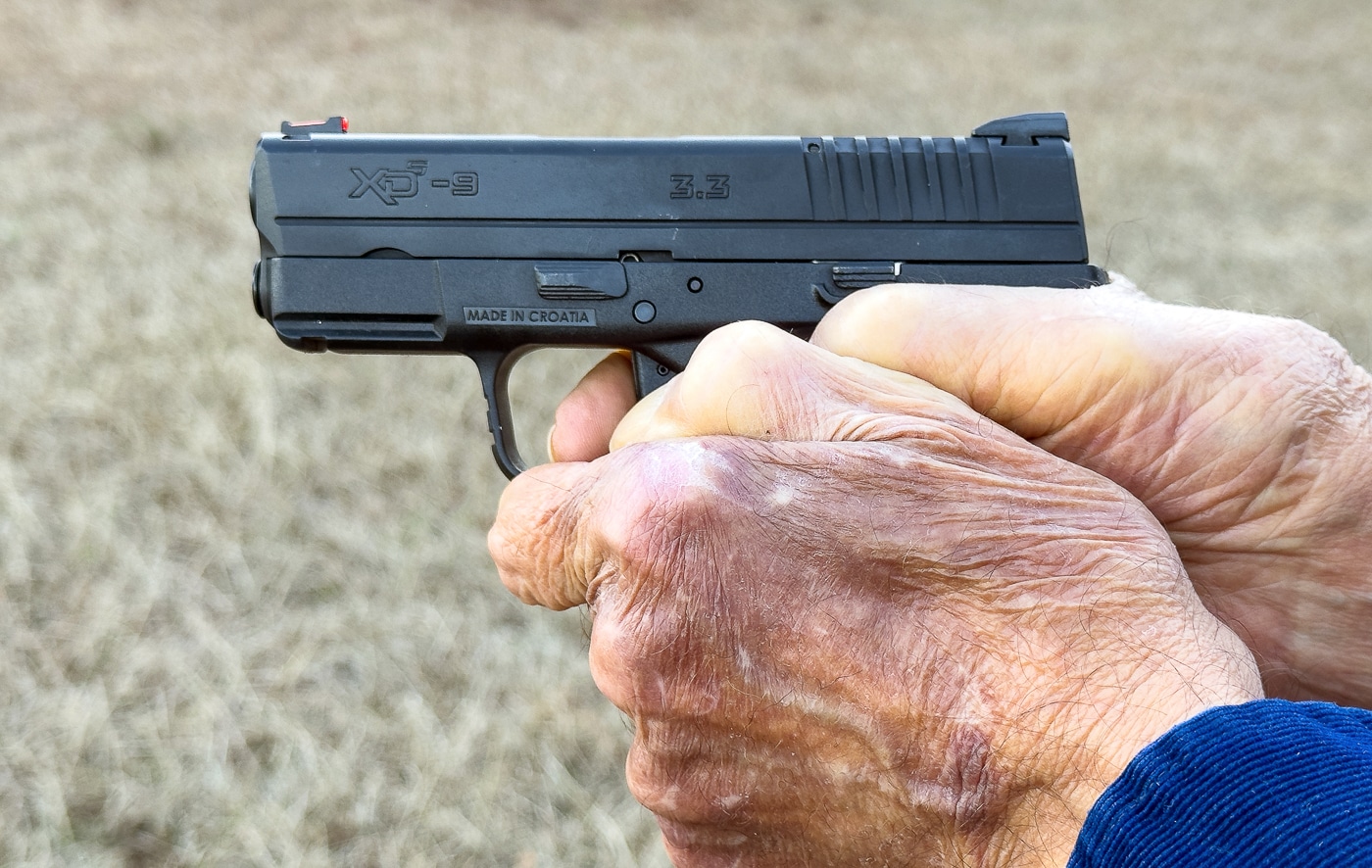 author demonstrates two handed grasp on Springfield Armory XD-S pistol
