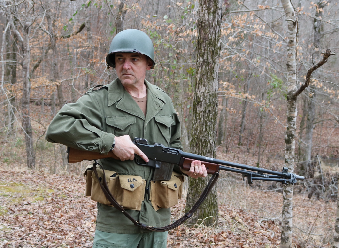author in a WWII uniform and armed with BAR