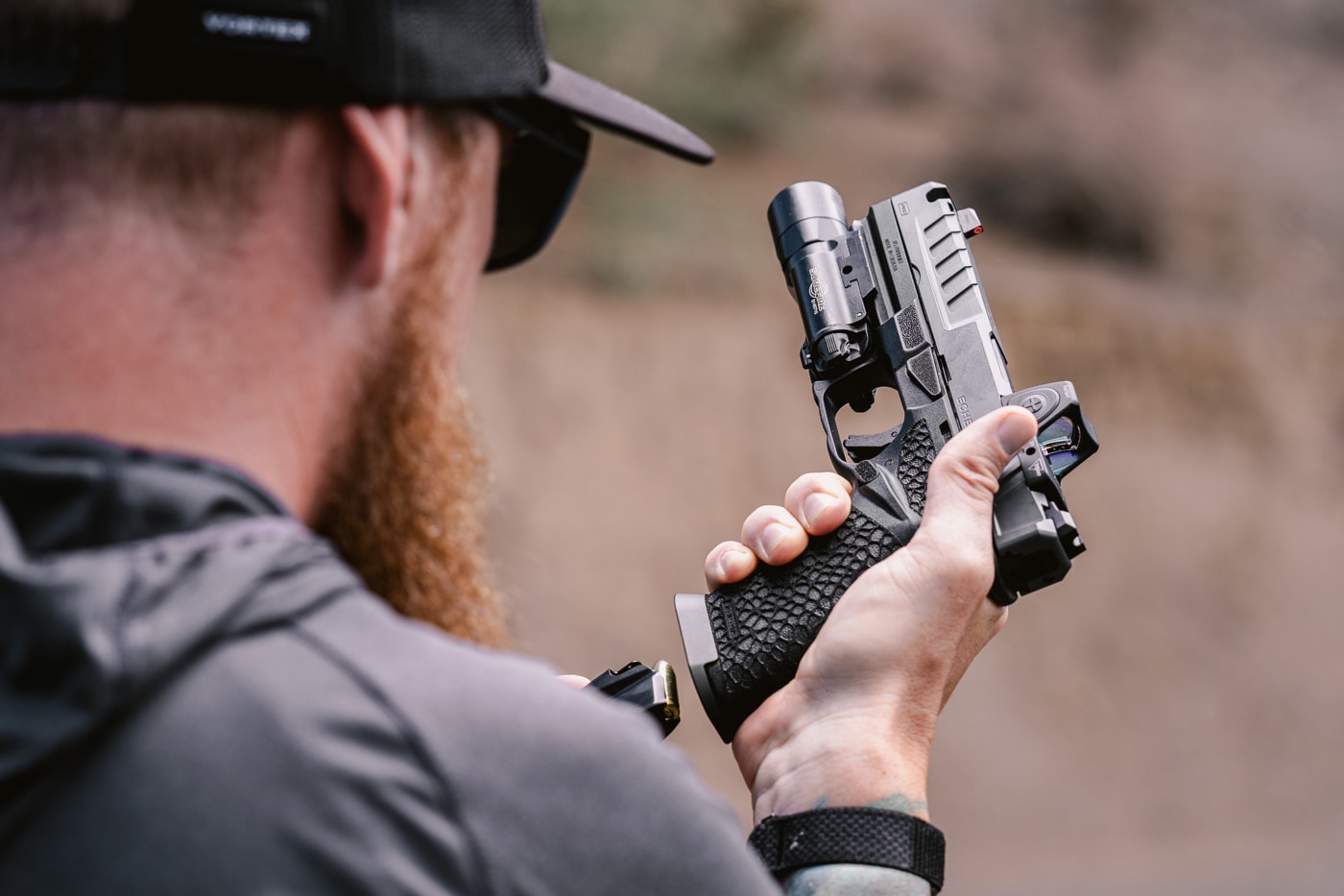 author reloading the Springfield Echelon Pro Comp on the shooting range