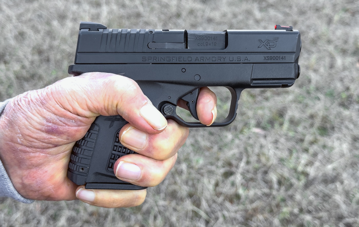 author wraps pinky finger under the magazine base when the pistol has a short grip