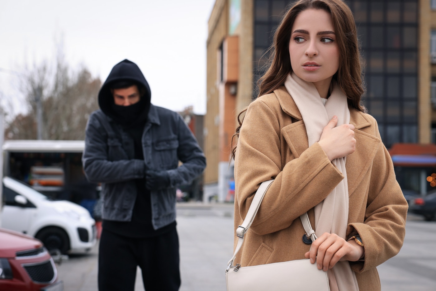 frightened woman is approached by a man who is going to steal her purse