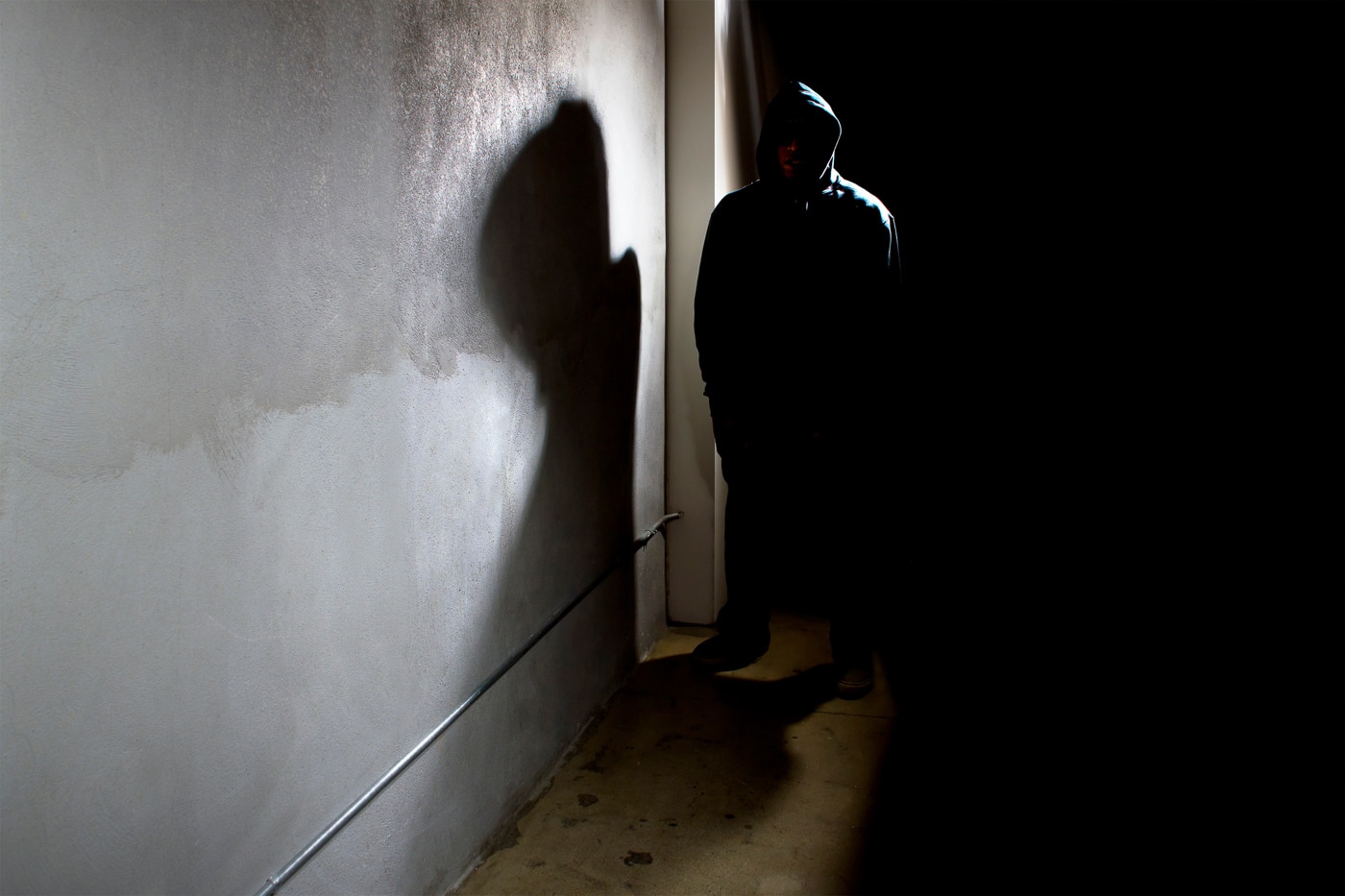 man in dark alley creates a high threat environment
